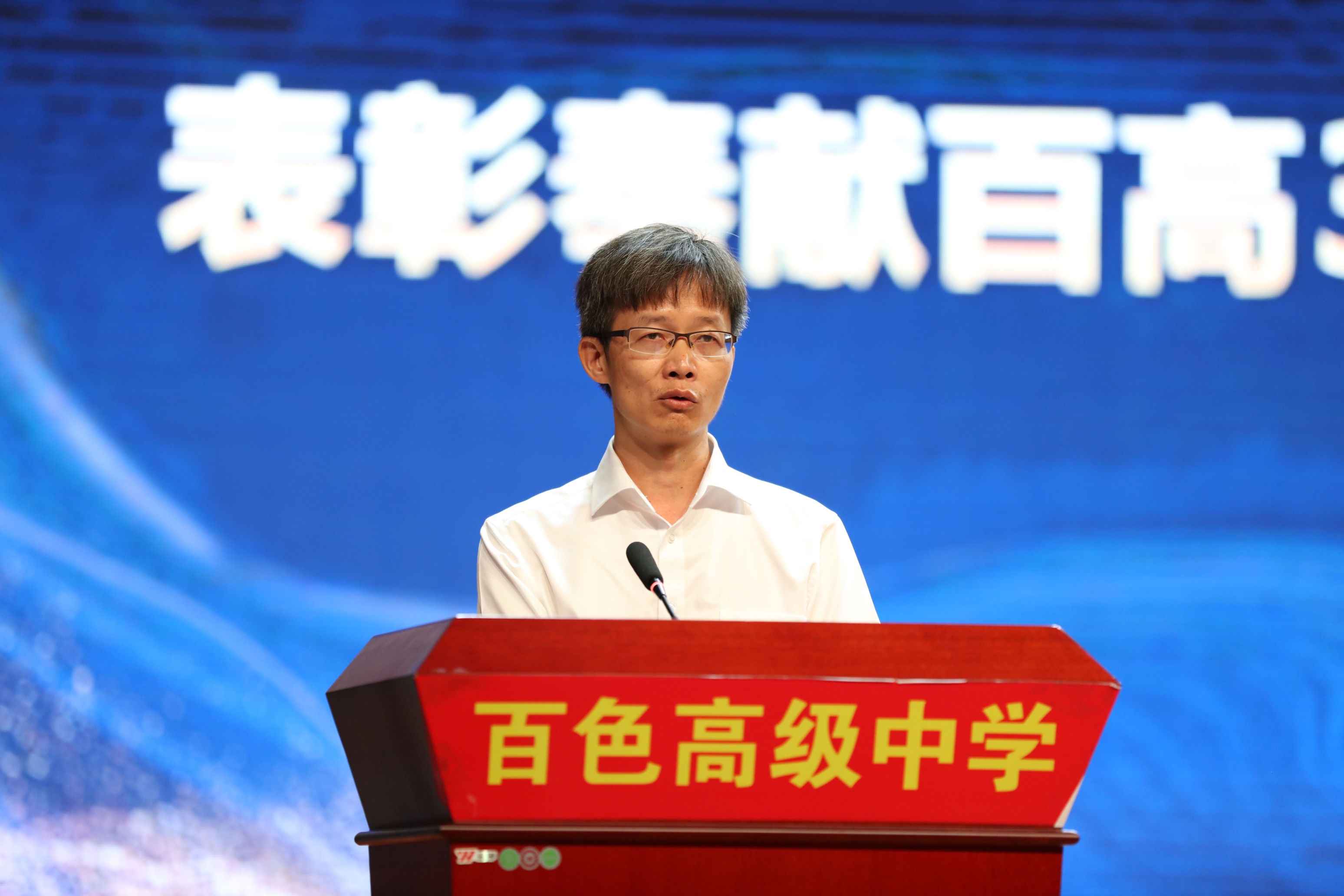 磨志功校长宣读表彰文件